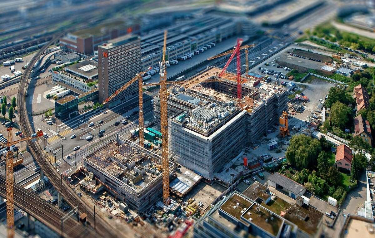 Construction site with worker reviewing plans